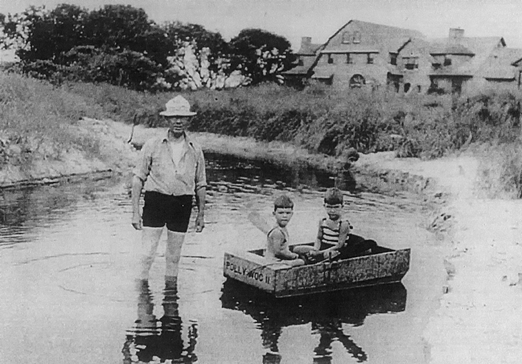 Henry C. White teaching his grandsons how to row a boat.