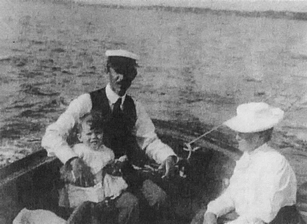 Henry and Grace White sailing with son John in their boat, ca. 1893.