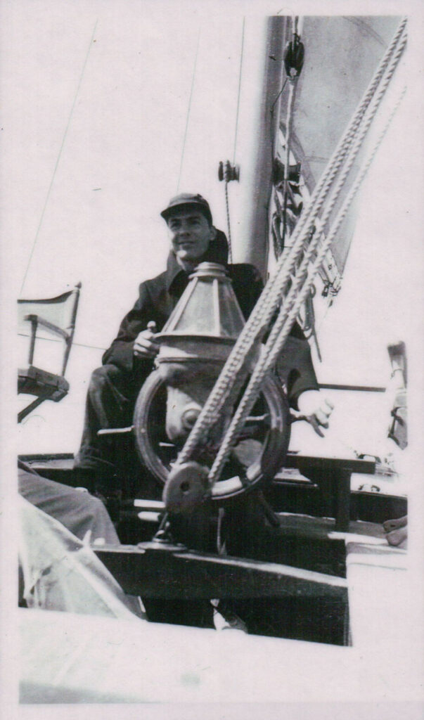 Nelson H White at the helm of the "Tabor Boy", Tabor Academy